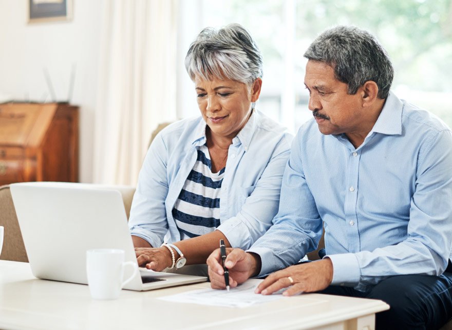 Husband and wife looking at their lite Valley Credit Union account on the computer together.